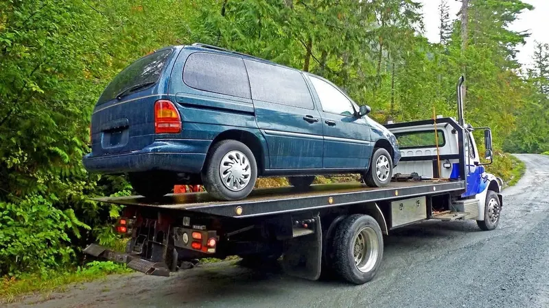 Orleans flatbed towing a cargo van