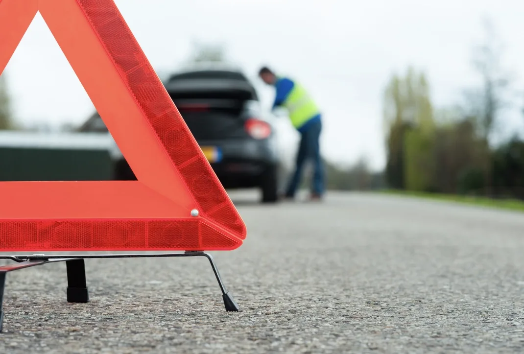 roadside assistance technician helping a driver